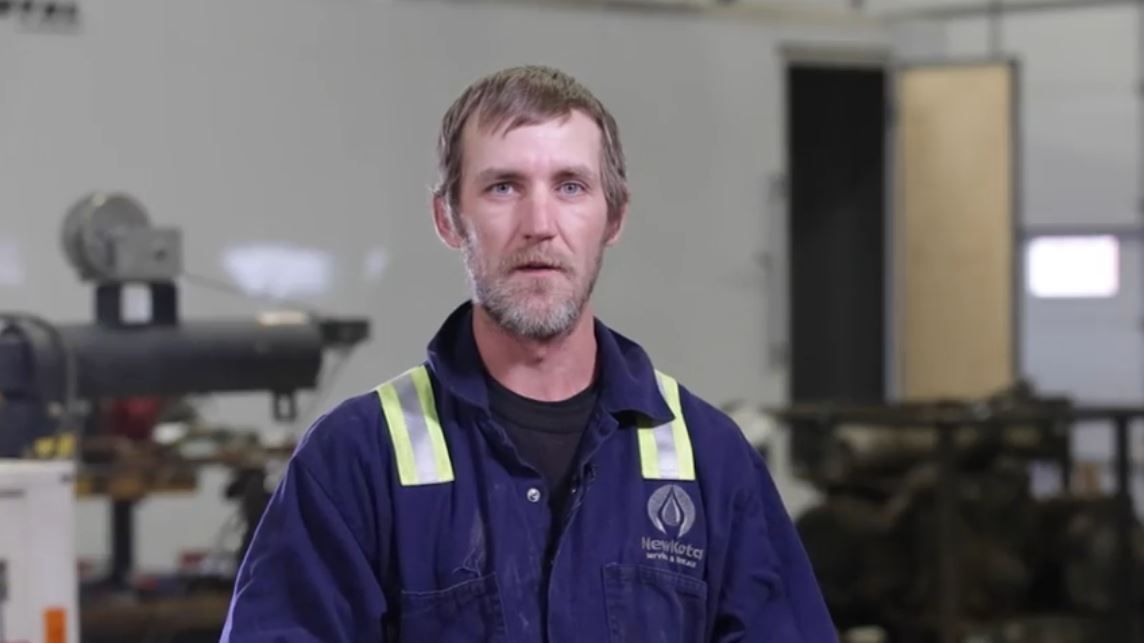 NewKota employee speaking on camera in the shop